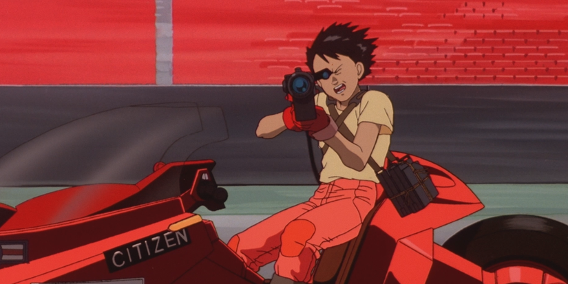 Shotaro Kaneda is aiming his gun while riding his motorcycle in Akira (1988).
