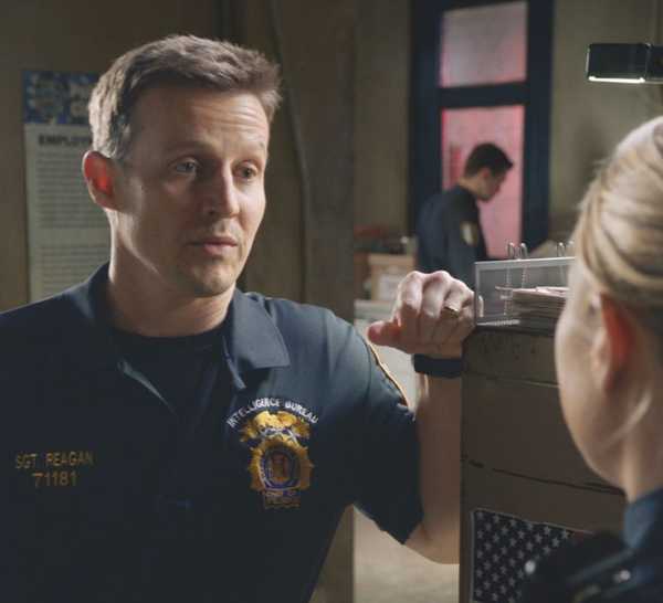 Jamie Reagan in his sergeant's uniform speaks to Eddie Janko at the precinct in Blue Bloods