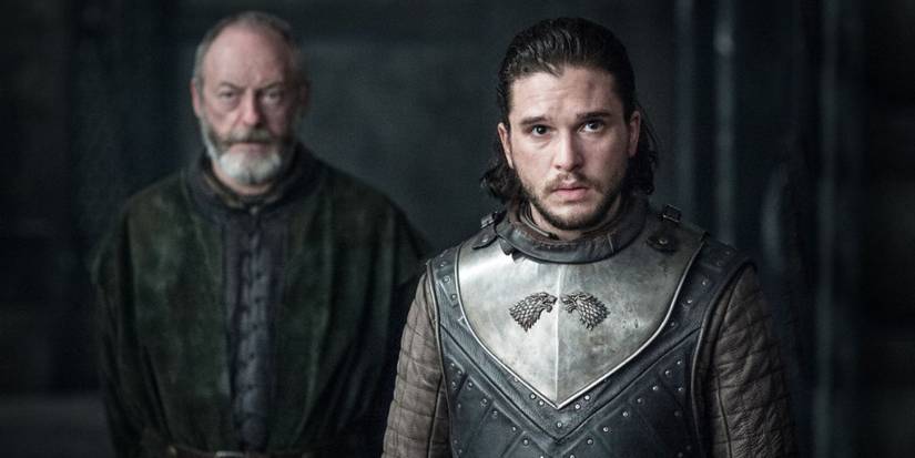 Davos Seaworth stands behind Jon Snow as they meet Daenerys Targaryen for the first time in Game of Thrones