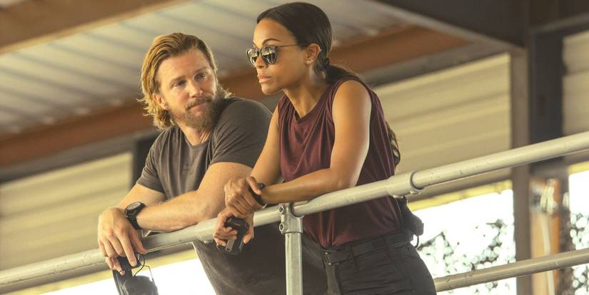 Kyle (Thad Luckinbill) looks at Joe (Zoe Saldana) as they lean together on a railing in Lioness