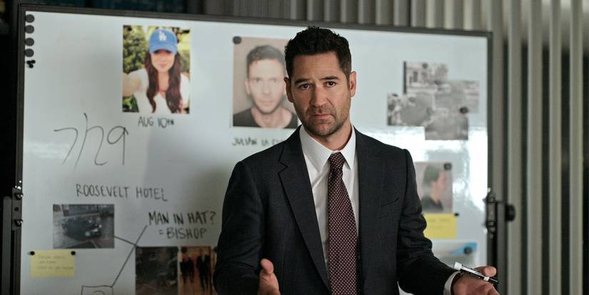 Mickey Haller wearing a suit and standing in front of a whiteboard in The Lincoln Lawyer Season 3