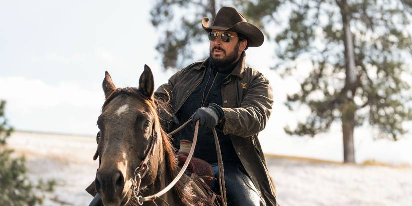 Rip Wheeler, played by actor Cole Hauser, riding a brown horse in Yellowstone.