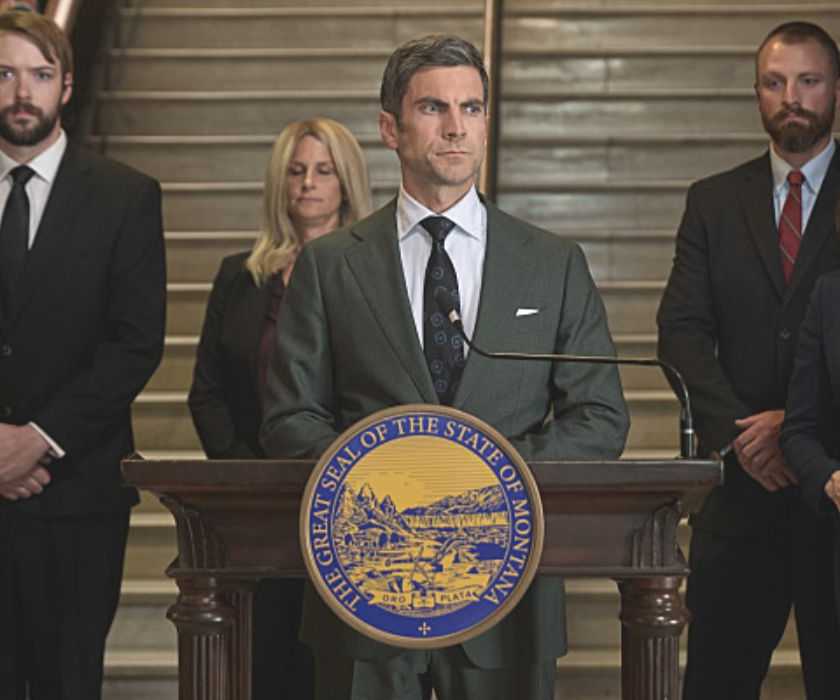 Jamie Dutton, played by actor Wes Bentley, stands at a podium with his staff in Yellowstone Season 5