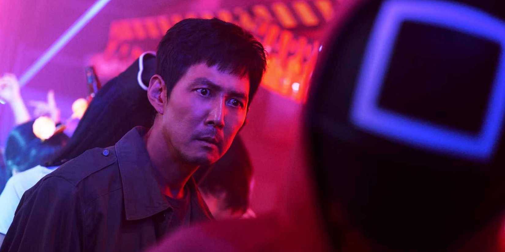 Gi-hun fights masked men in Squid Game Season 2.