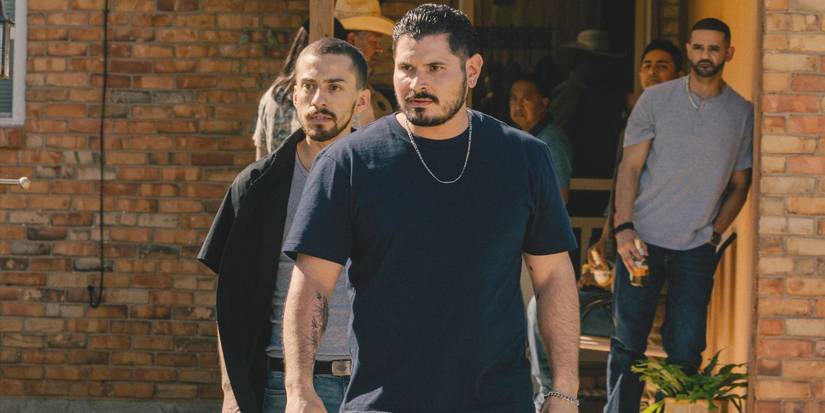 Antonio and Manuel stand menacingly outside their home with family looking on in Landman