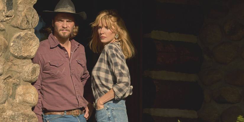 Kayce Dutton (Luke Grimes) and Beth Dutton stand next to one another beside a wall in Yellowstone