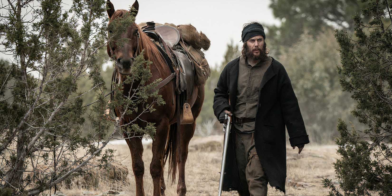 Taylor Kitsch's Isaac Reed holds a gun in American Primeval