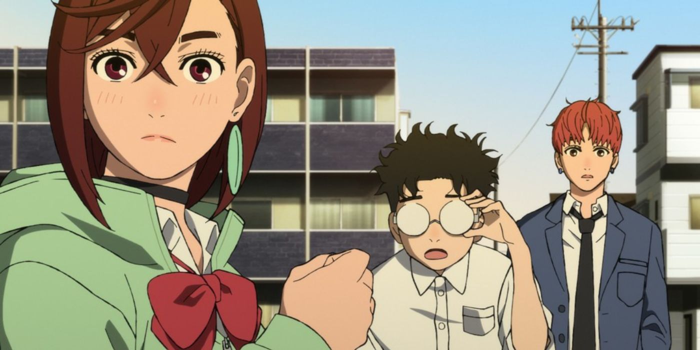 Momo, Okarun, and Jiji look curiously at something in the Dandadan anime.