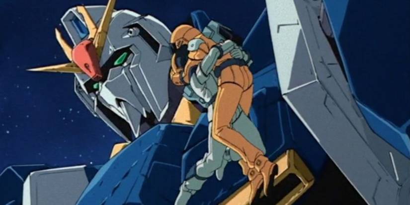 Kamille and Fa hugging in front of the Zeta Gundam in Mobile Suit Zeta Gundam.