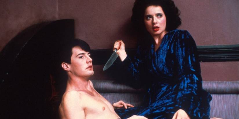 Dorothy (Isabella Rossellini) raises a knife over Jeffrey (Kyle MacLachlan) in Blue Velvet.