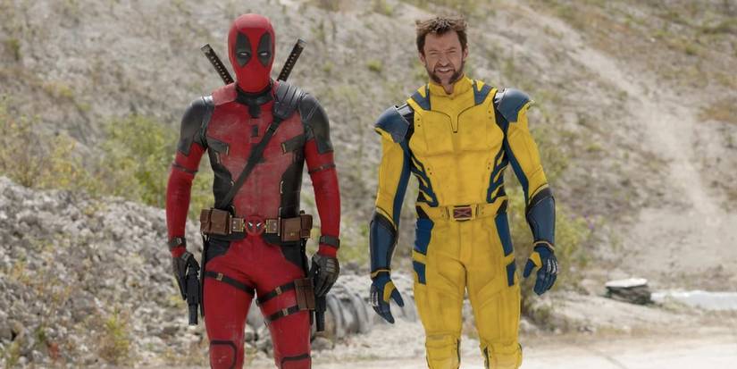 Deadpool in his red suit stands next to Wolverine in his blue & yellow suit in Deadpool & Wolverine