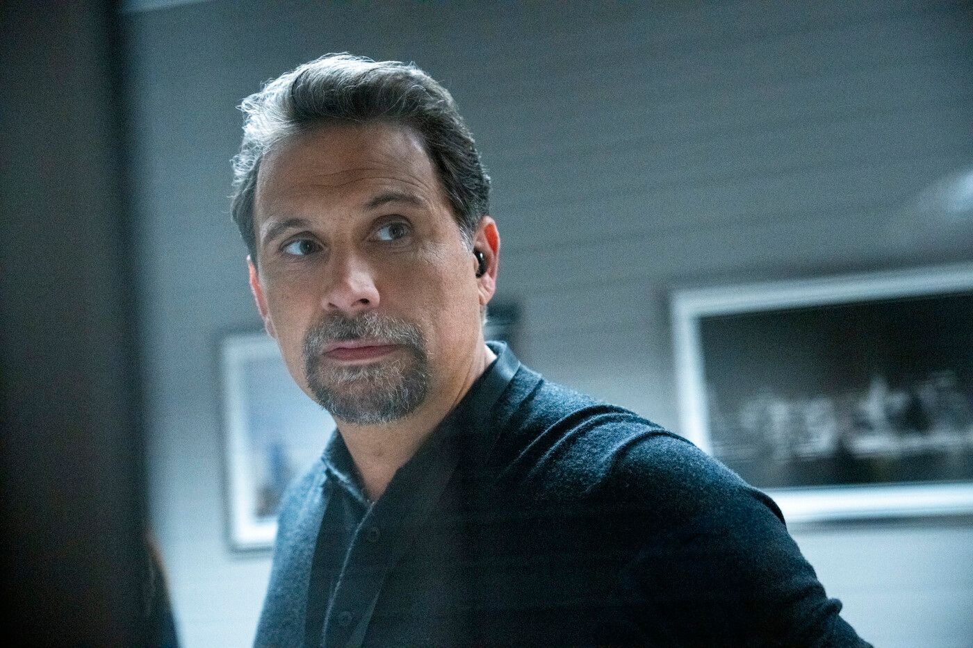 Close-up of Jubal Valentine, played by Jeremy Sisto, wearing a black polo shirt in the TV show FBI