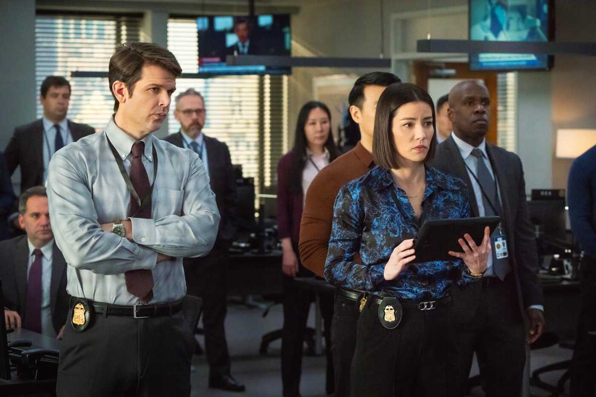 A group of FBI agents stands together in the bullpen in FBI Season 7, Episode 11