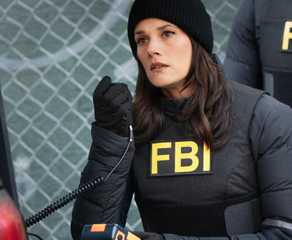Maggie Bell, played by Missy Peregrym, wearing black FBI gear and holding a microphone in FBI