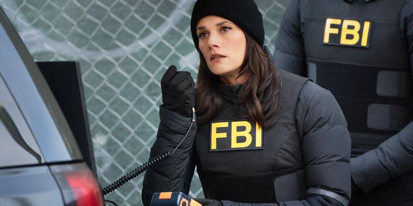 Maggie Bell, played by Missy Peregrym, wearing black FBI gear and holding a microphone in FBI