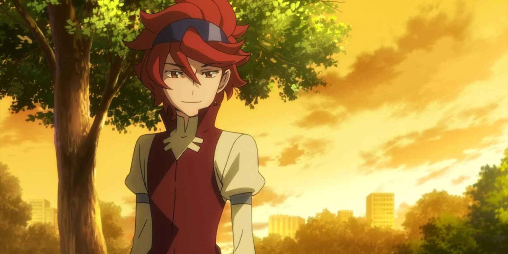 Reiji from Gundam Build Fighters standing in front of a tree while the sun sets.