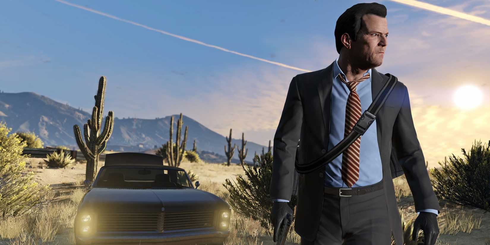 Michael De Santa stands in front of a car in the desert in Grand Theft Auto V