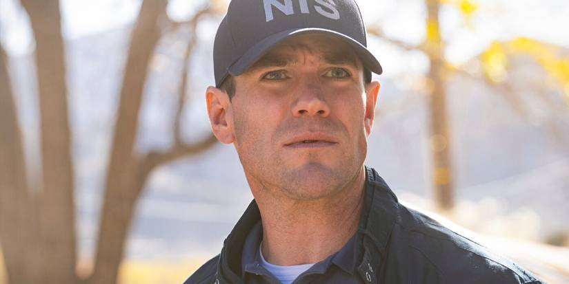 Young Gibbs, played by actor Austin Stowell, wearing a blue NIS cap and windbreaker in NCIS: Origins