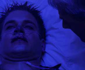 Tony in bed in a hazmat hospital in NCIS