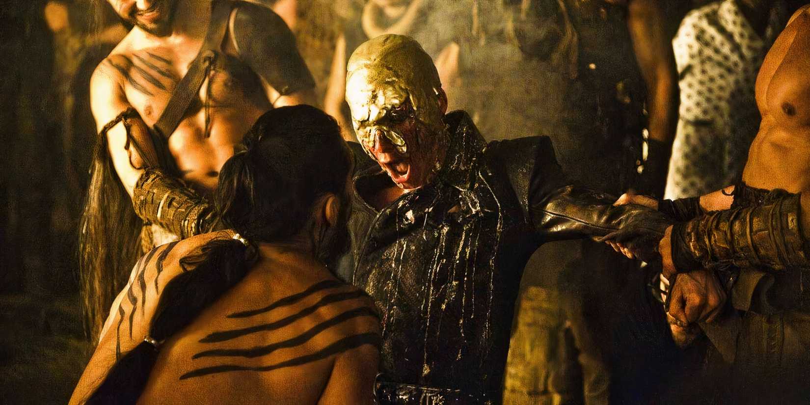 Viserys Targaryen with melted gold poured over his head as Khal Drogo stares on.