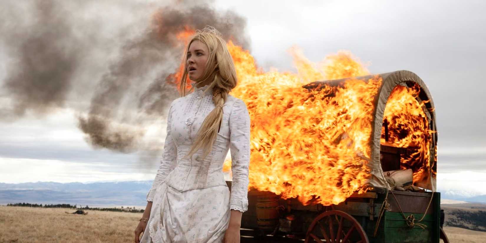 Isabel May stands in front of a wagon set on fire in 1883.