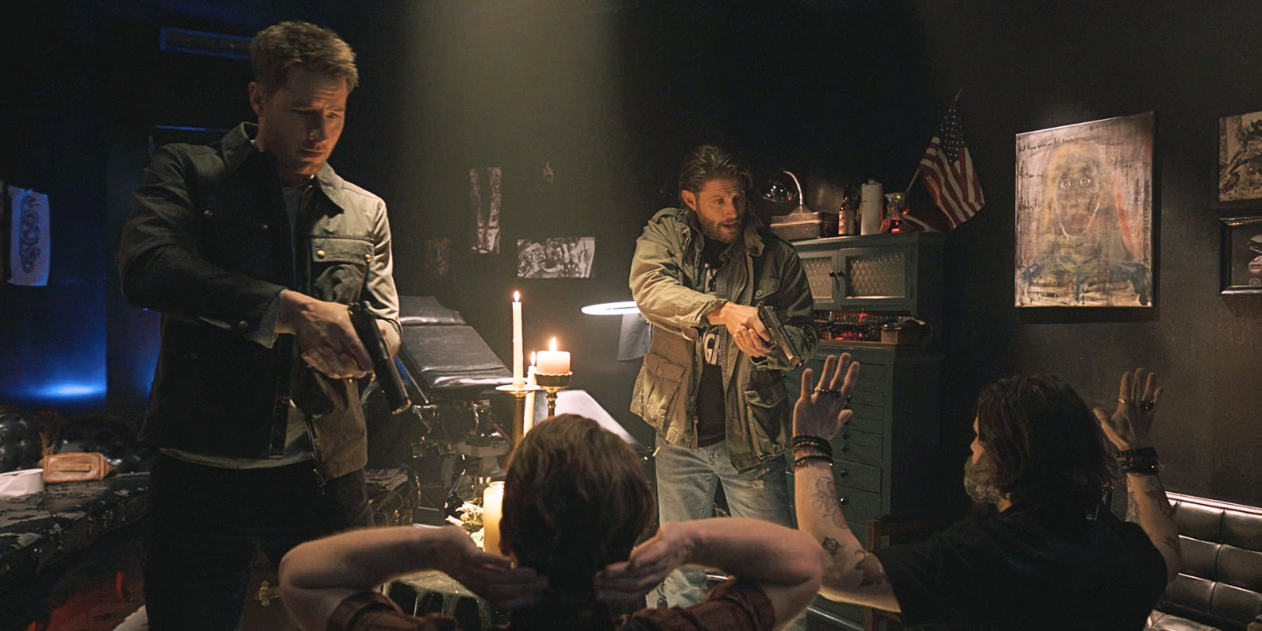 Justin Hartley as Colter and Jensen Ackles as Russell holding occultists at gunpoint in Tracker 'Off the Books'