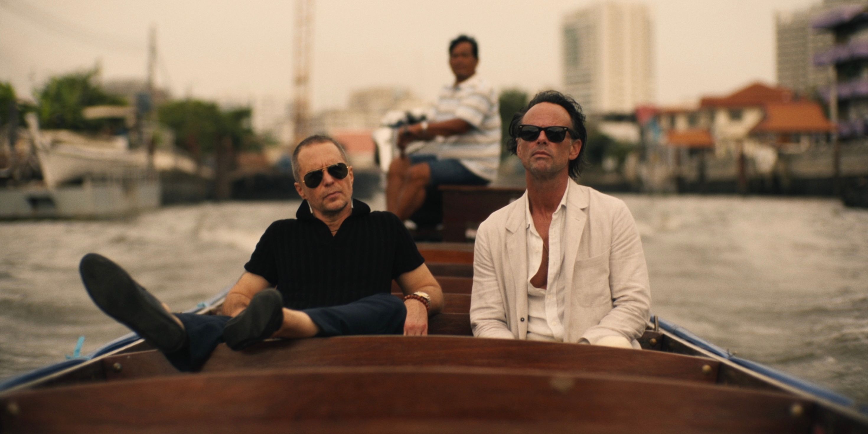 Frank (Sam Rockwell) and Rick (Walton Goggins) riding in a boat on a river on The White Lotus