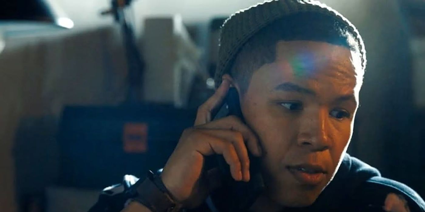 Bobby turned to the side on the phone looking serious on Tracker.