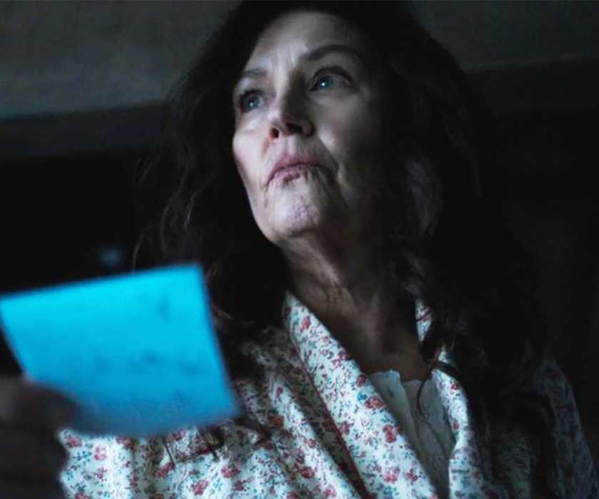 Mary in a robe looking worried while holding a note in Tracker.