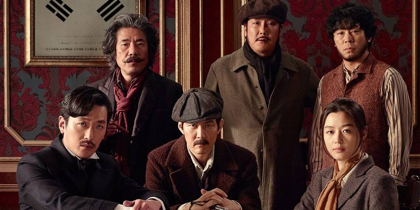 The main crew in Assassination (2015) gather around a table