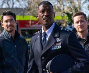 Tyler Booth and Wes Mitchell stand on either side of General Finley in TV show FBI: International