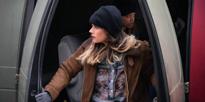 Maggie steps out of a van wearing a brown jacket and beanie in the TV show FBI