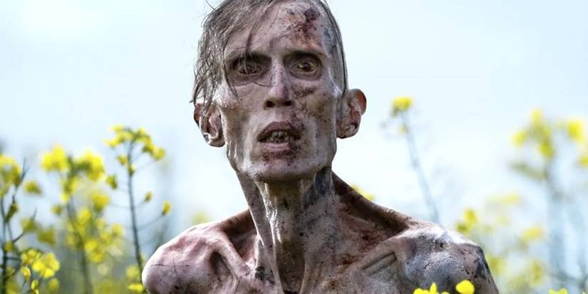 A close-up of an infected human standing in a field in the movie 28 Years Later