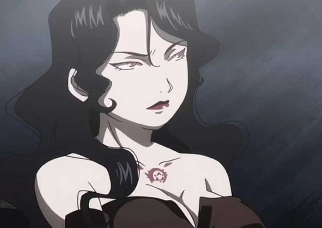 Lust makes a serious face in a dark room.