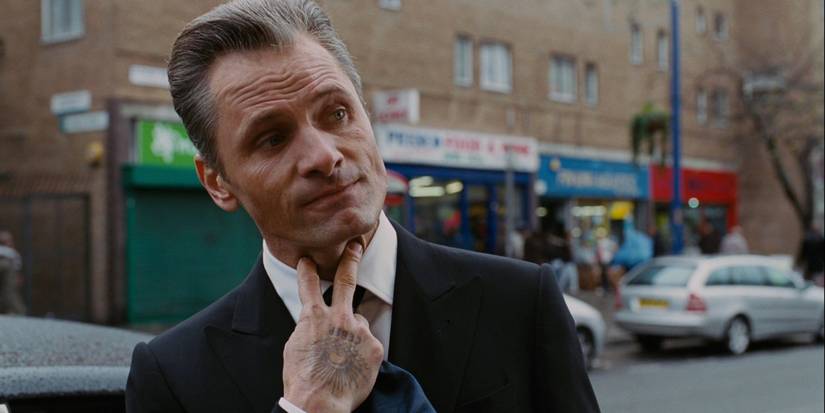 Viggo Mortensen as Nikolai Luzhin, holding his fingers to his throat in David Cronenberg's Eastern Promises