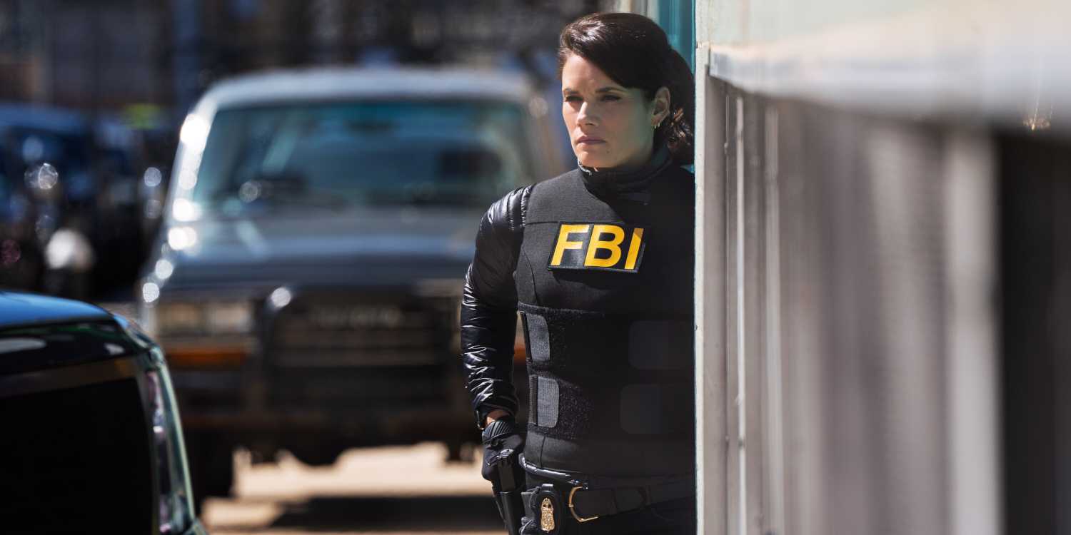 Maggie Bell, played by Missy Peregrym, stands on a street corner in black FBI tactical gear on FBI