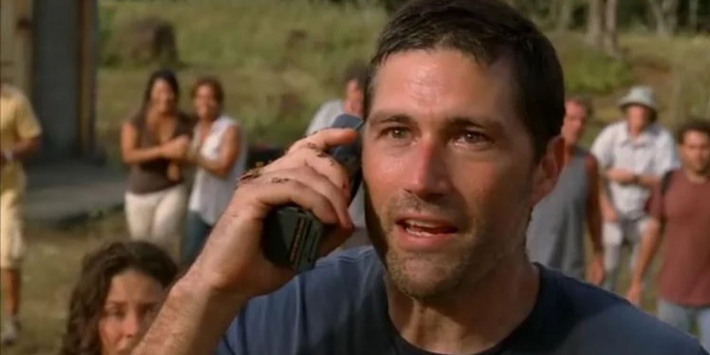 Lost - Jack is using the satellite phone while the other islanders stand behind him.
