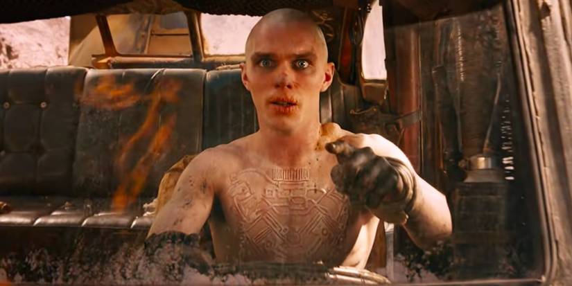 A shirtless Nicholas Hoult as Nux, driving the War rig from the 2015 film Mad Max: Fury Road.