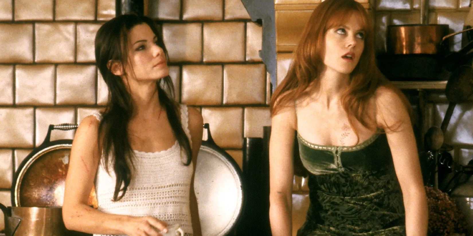 Sally wearing white blouse and Gillian wearing black top, standing together in movie Practical Magic