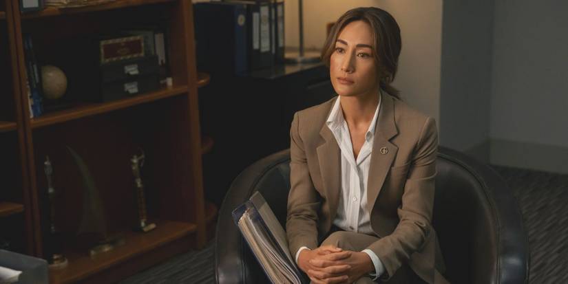 Renee Ballard, played by Maggie Q, seated with a tanning costume in the first -rate Ballard video television show