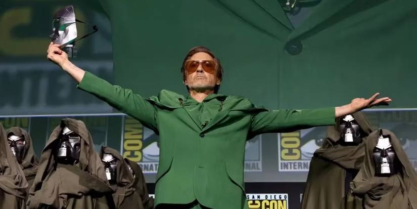 Robert Downey Jr. wearing a green suit and raising his arms as Doctor Doom at SDCC