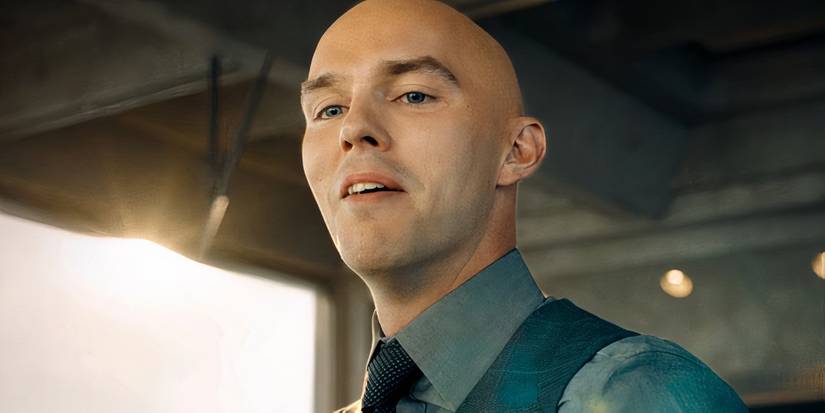 Lex Luthor, played by Nicholas Hoult, smiling, wearing a blue shirt and a tie in the film 2025 Superman
