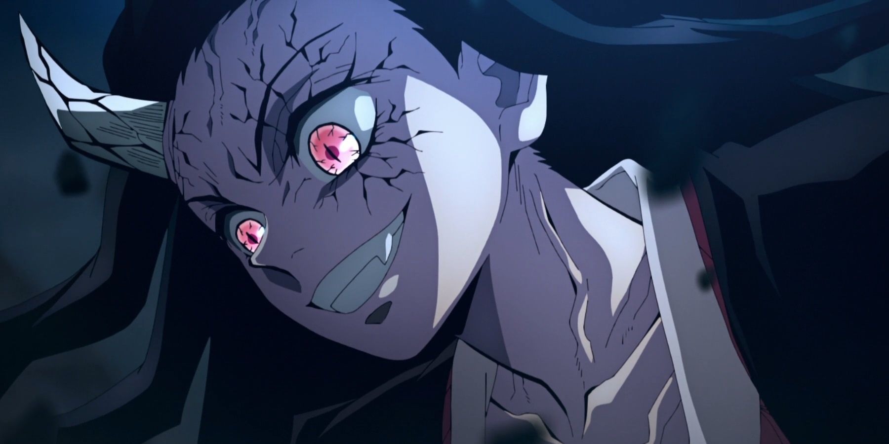 Nezuko smiles widely while fighting in the form of a demon.