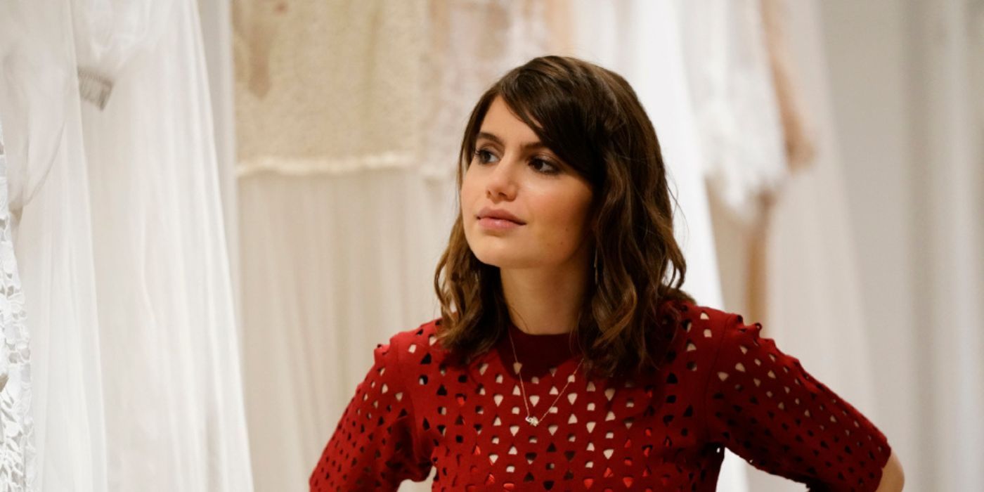 Nicky Reagan-Boyle stares at someone offscreen among wedding dresses in Blue Bloods