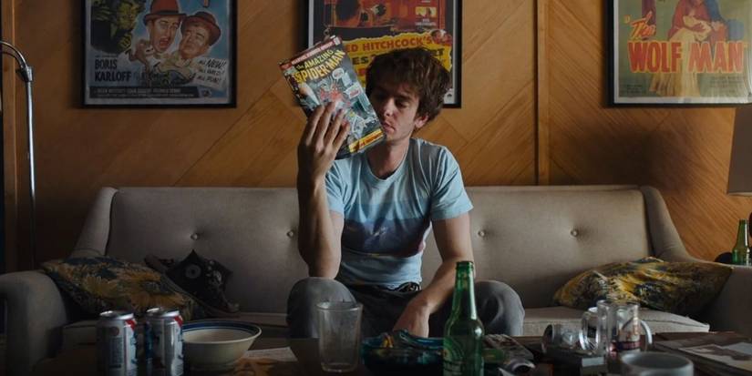 Andrew Garfield holding a Spider-Man comic book in Under the Silver Lake