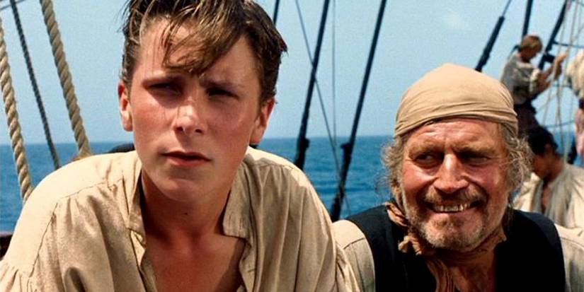 Christian Bale Jim Hawkins and Charlton Heston as Long John Silver sailing on a ship in Treasure Island 1990-1