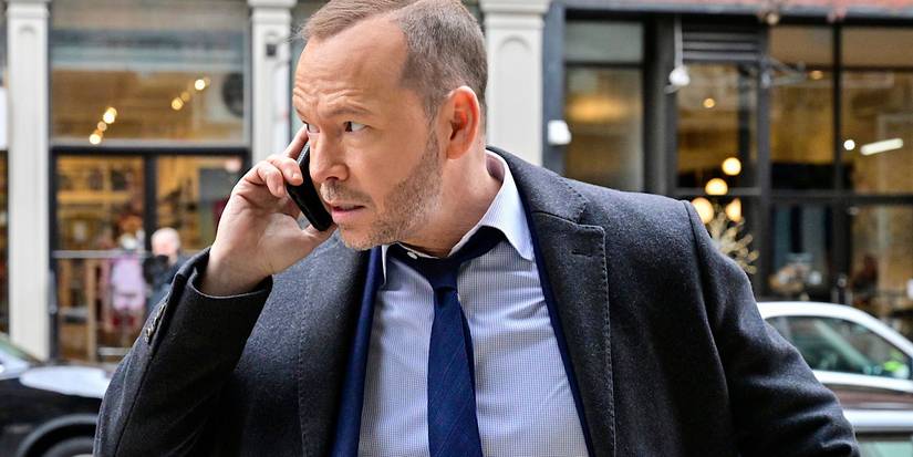 Danny Reagan is on the phone in the middle of the street.