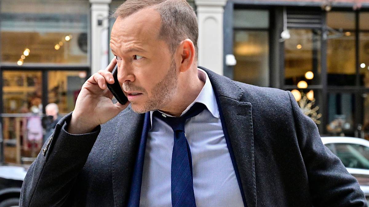 Danny Reagan is on the phone in the middle of the street.