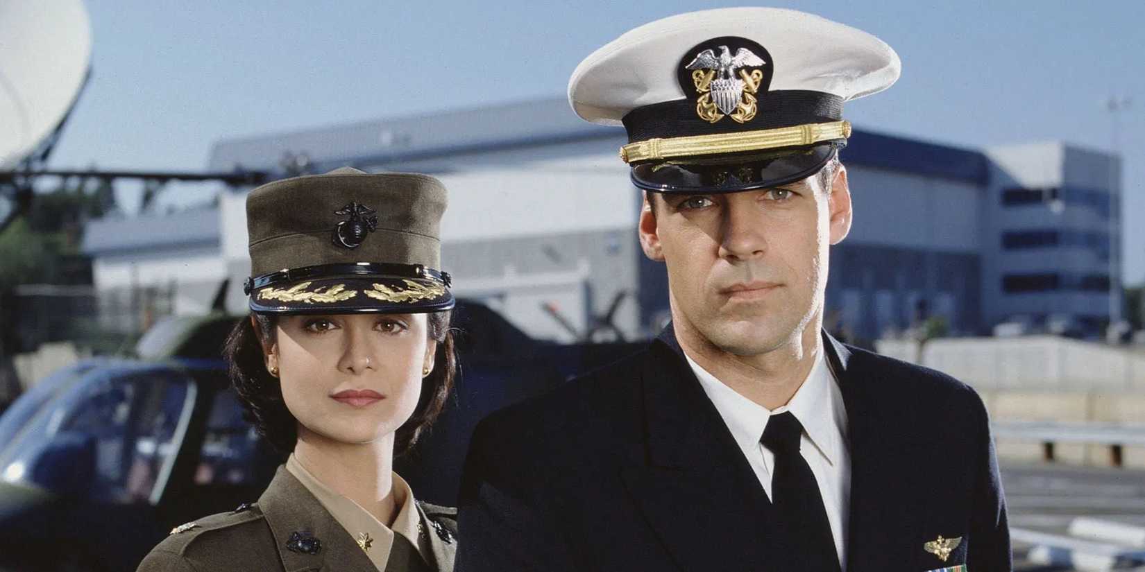 Harmon "Harm" Rabb Jr. and Sarah "Mac" MacKenzie pose in front of a helicopter in JAG
