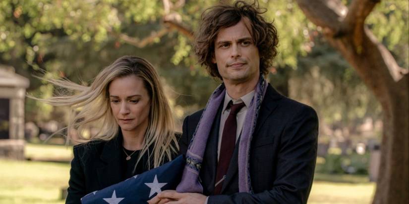 JJ holds onto an American Flag while Spencer Reid comforts her at Will's funeral in Criminal Minds Evolution